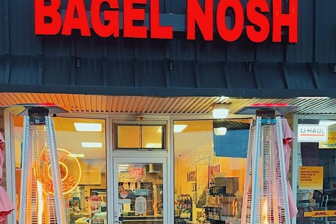 The Bagel Nosh storefront on Main Street in Madison with patio heaters glowing at dusk